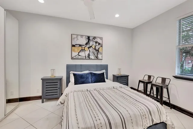 a bedroom with a bed and a painting on the wall