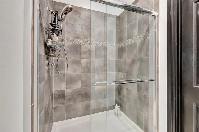 a bathroom with a glass shower door
