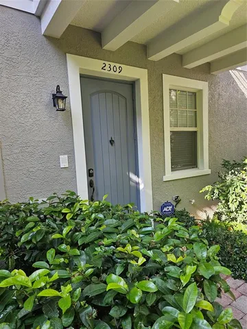 a view of a house with a flower garden