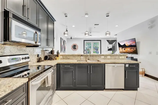 a kitchen with a sink stove and cabinets