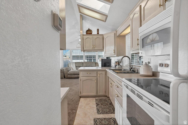 2990 East Riverside Drive, Unit 173 St. George, UT 84790 - Photo 9 of 38 Galley kitchen featuring light cabinetry, integrated appliances, and a skylight for natural illumination