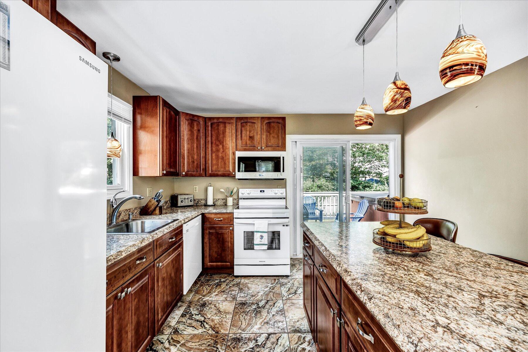 127 South Sandwich Road Mashpee, MA 02649 - Photo 11 of 55 a kitchen with a stove a sink and a refrigerator