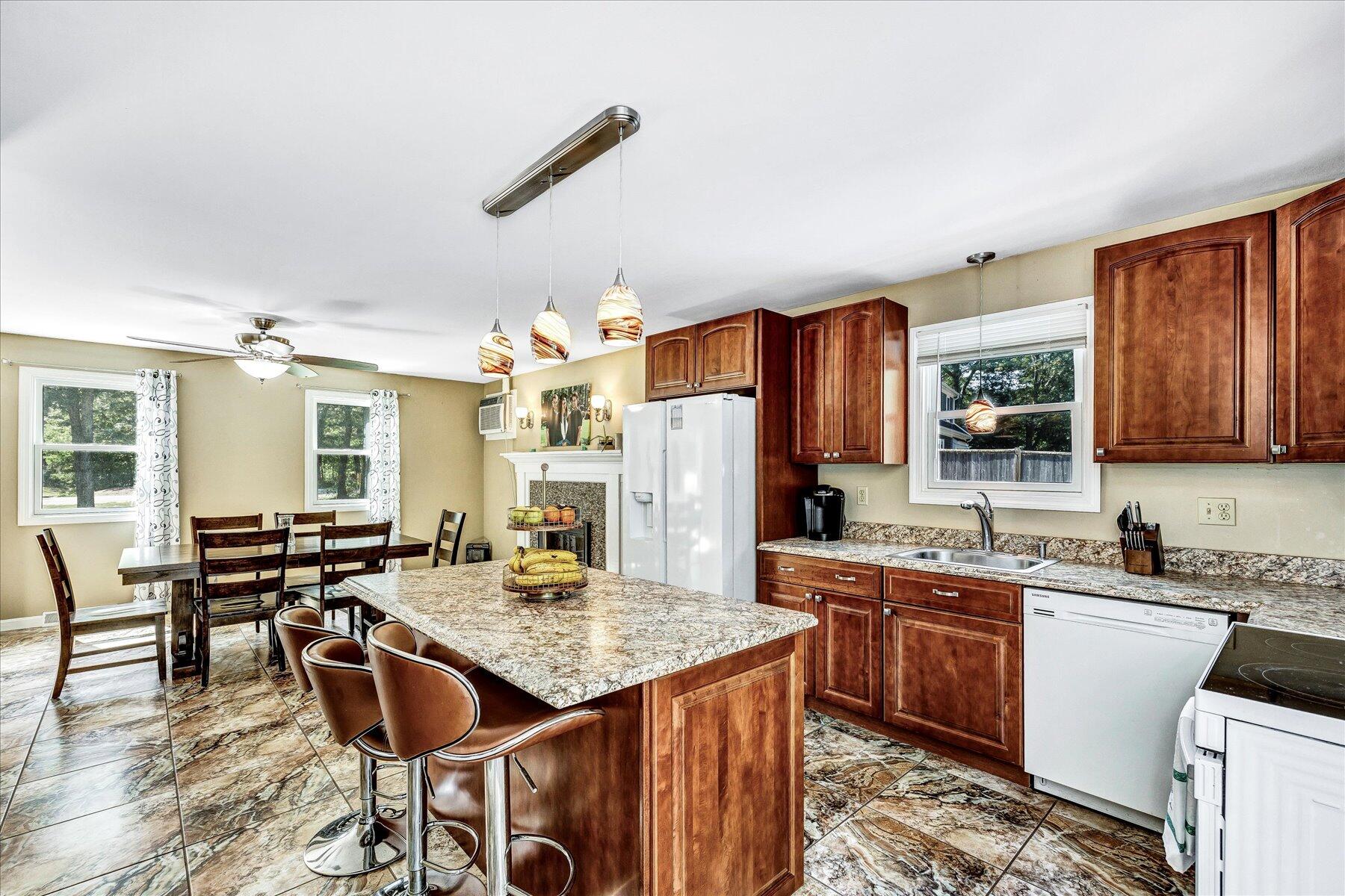 127 South Sandwich Road Mashpee, MA 02649 - Photo 14 of 55 a kitchen with a stove a sink dishwasher and a refrigerator