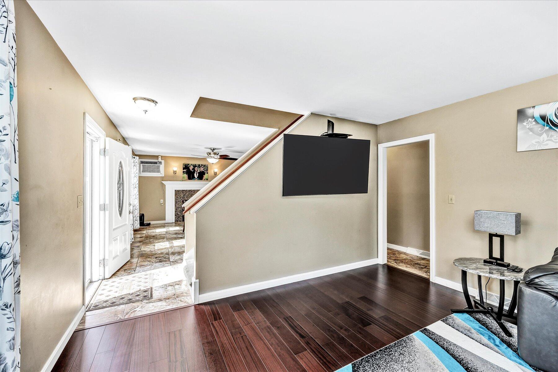127 South Sandwich Road Mashpee, MA 02649 - Photo 15 of 55 a view of a livingroom with wooden floor and stairs