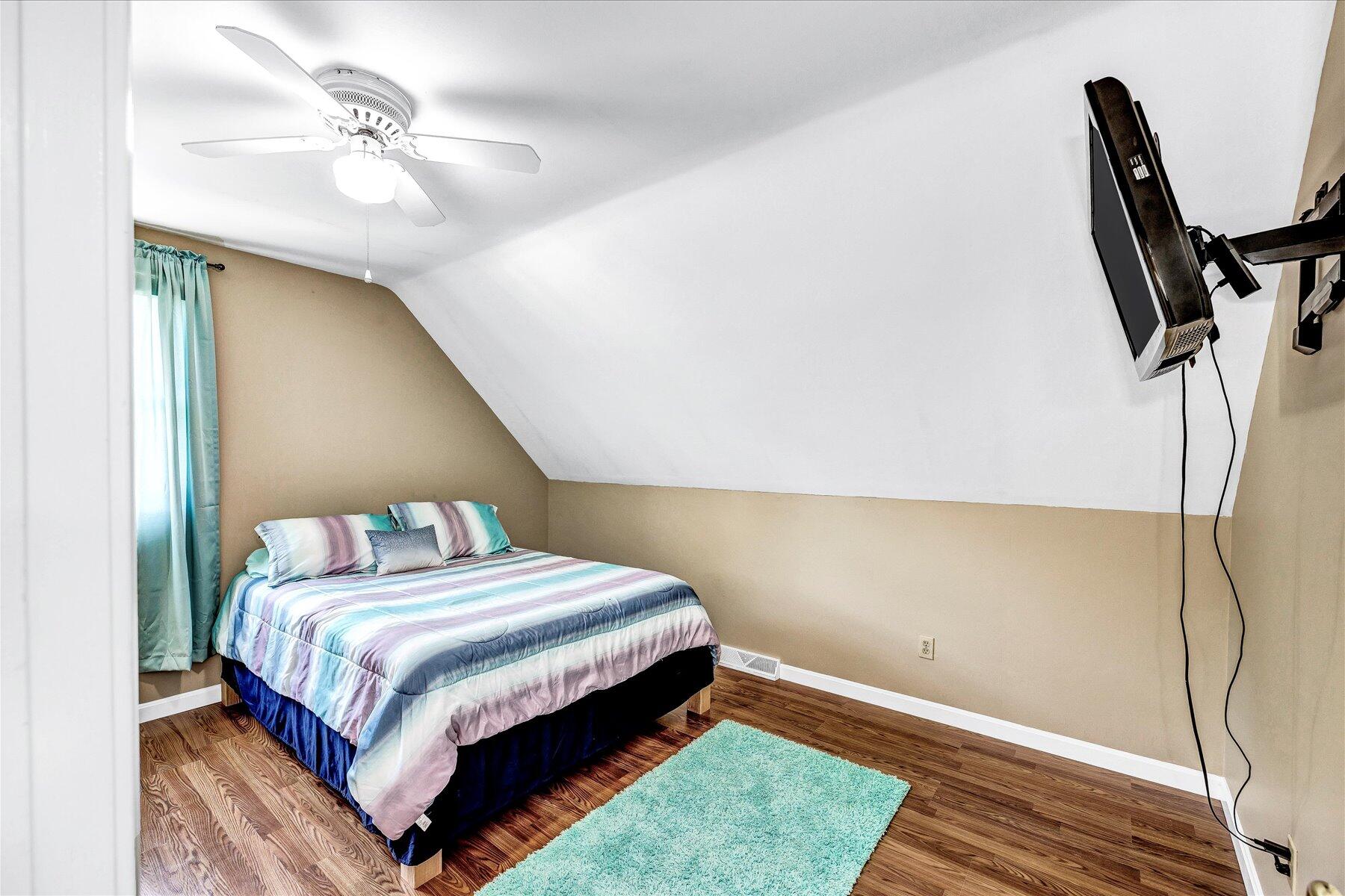 127 South Sandwich Road Mashpee, MA 02649 - Photo 30 of 55 a bedroom with a bed and a chandelier