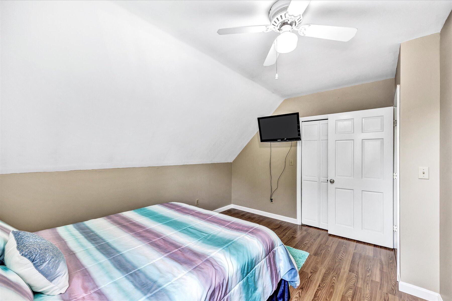 127 South Sandwich Road Mashpee, MA 02649 - Photo 31 of 55 a bedroom with a bed and a chandelier