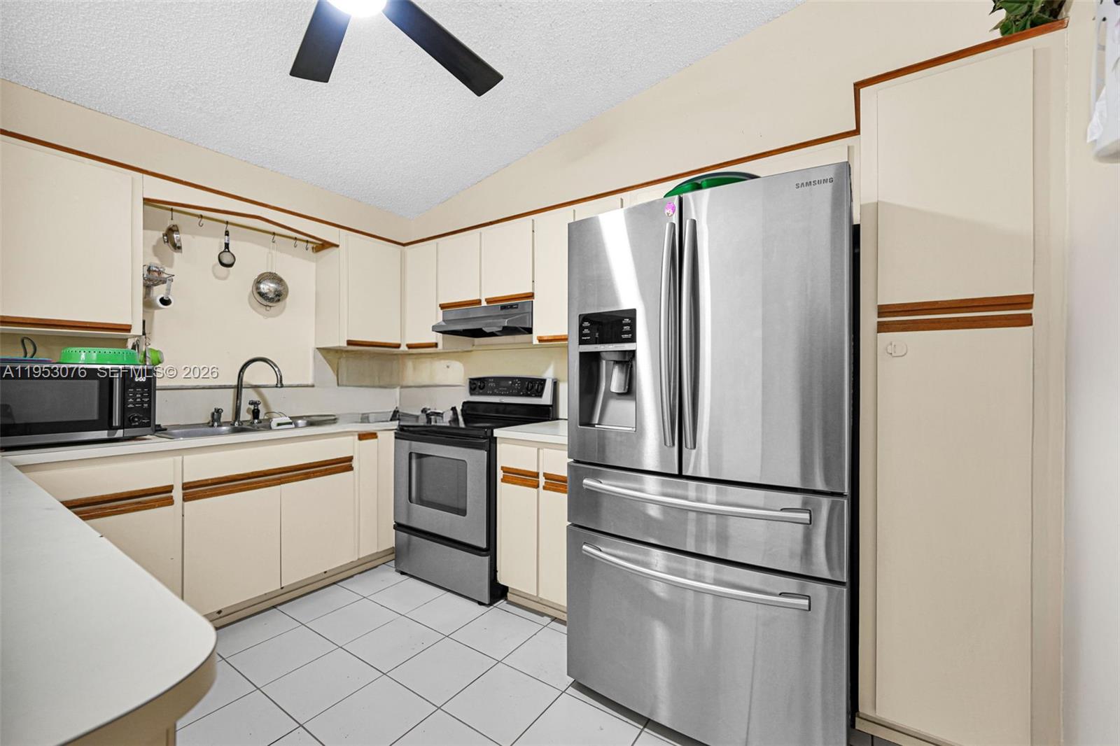 14837 Southwest 60th Street Miami, FL 33193 - Photo 11 of 21 a kitchen with stainless steel appliances a refrigerator sink and cabinets