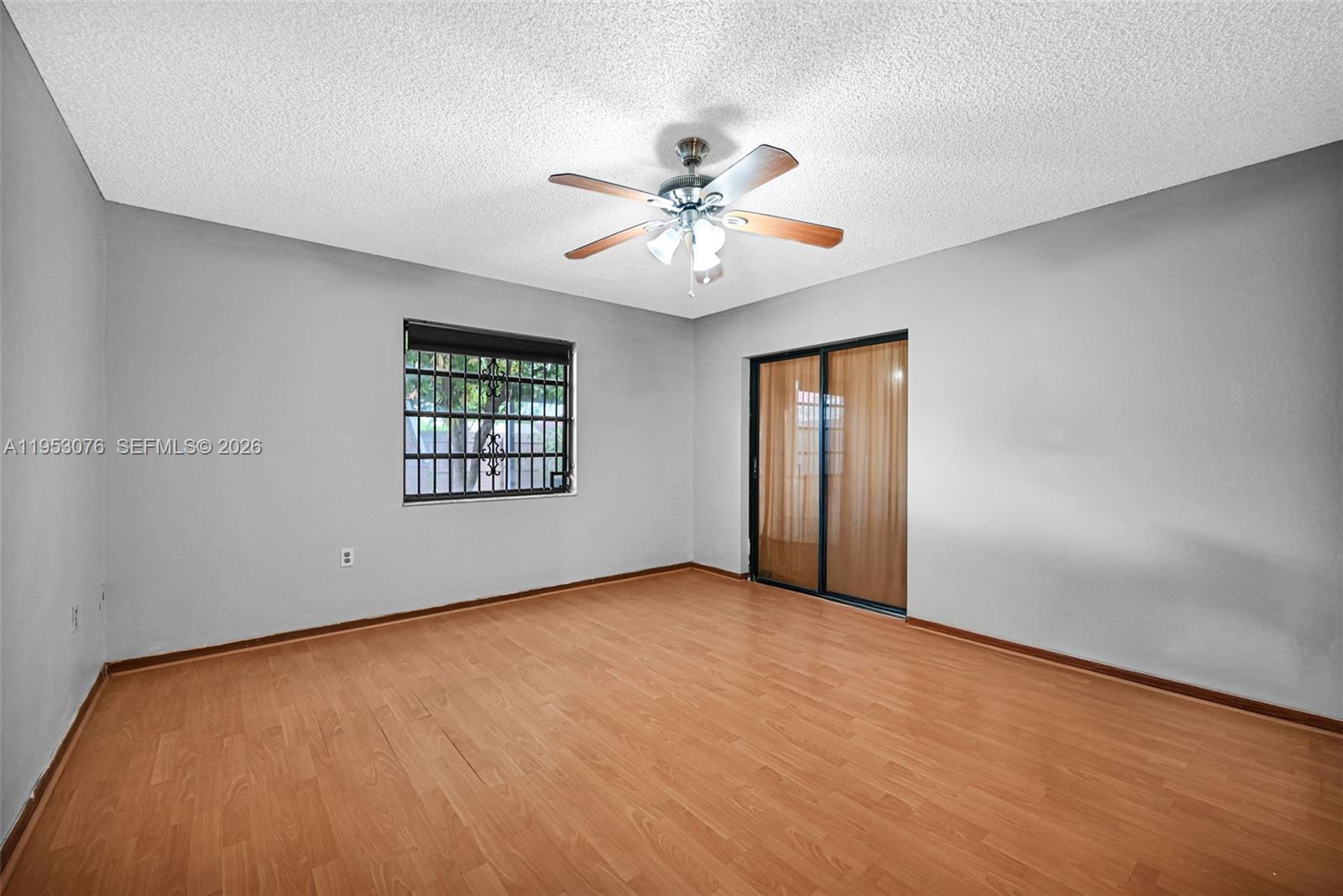 14837 Southwest 60th Street Miami, FL 33193 - Photo 12 of 21 an empty room with windows and fan