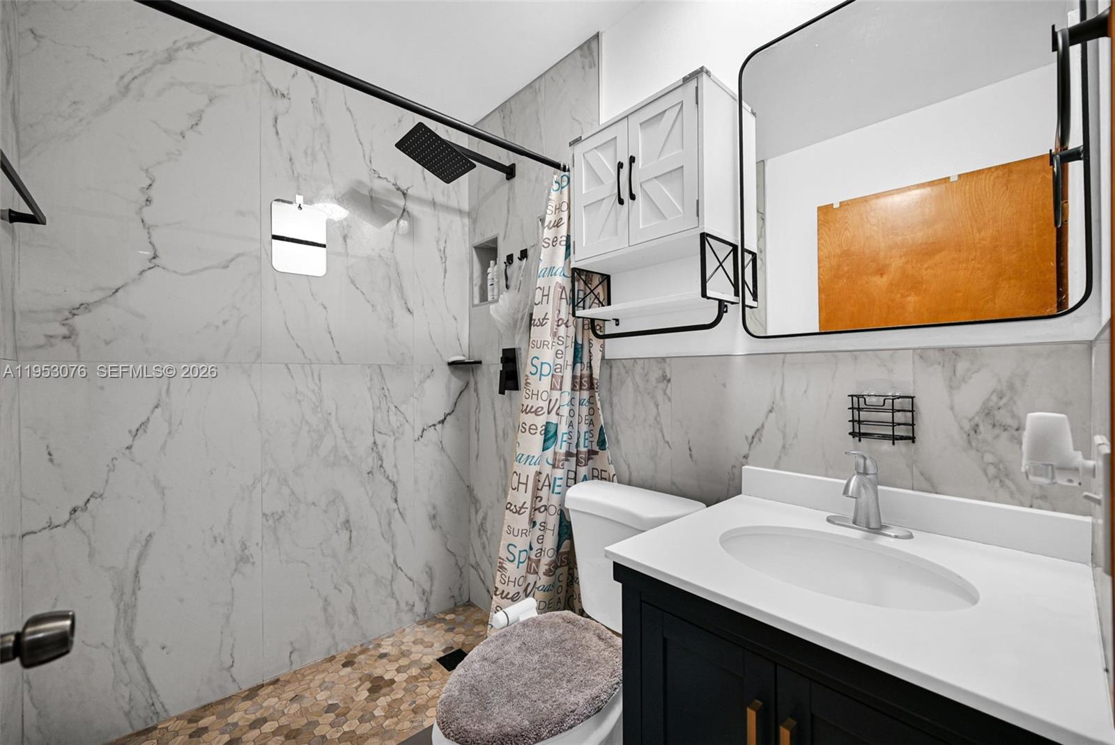 14837 Southwest 60th Street Miami, FL 33193 - Photo 16 of 21 a bathroom with a sink a mirror and a shower