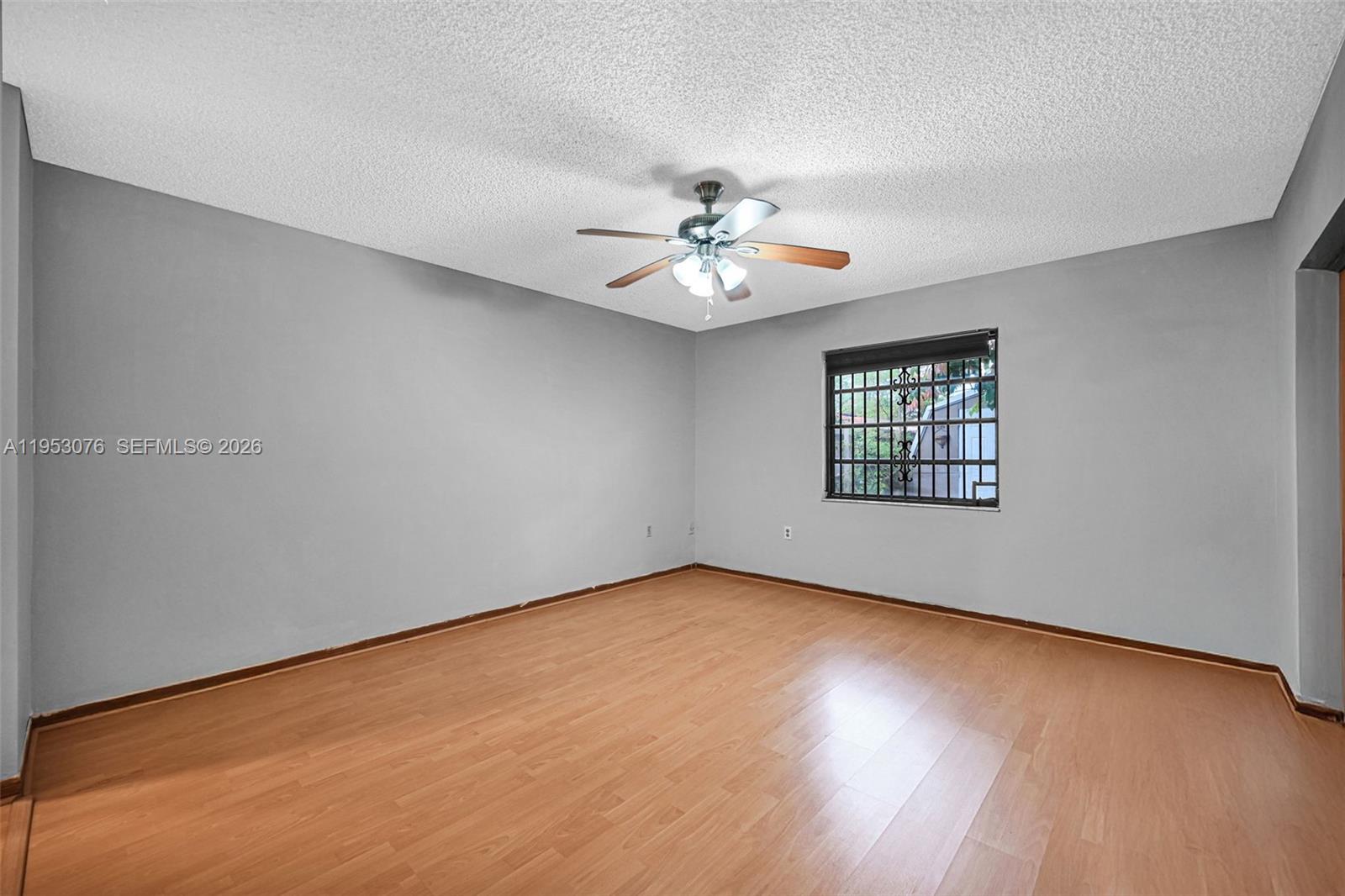 14837 Southwest 60th Street Miami, FL 33193 - Photo 18 of 21 an empty room with windows and ceiling fan