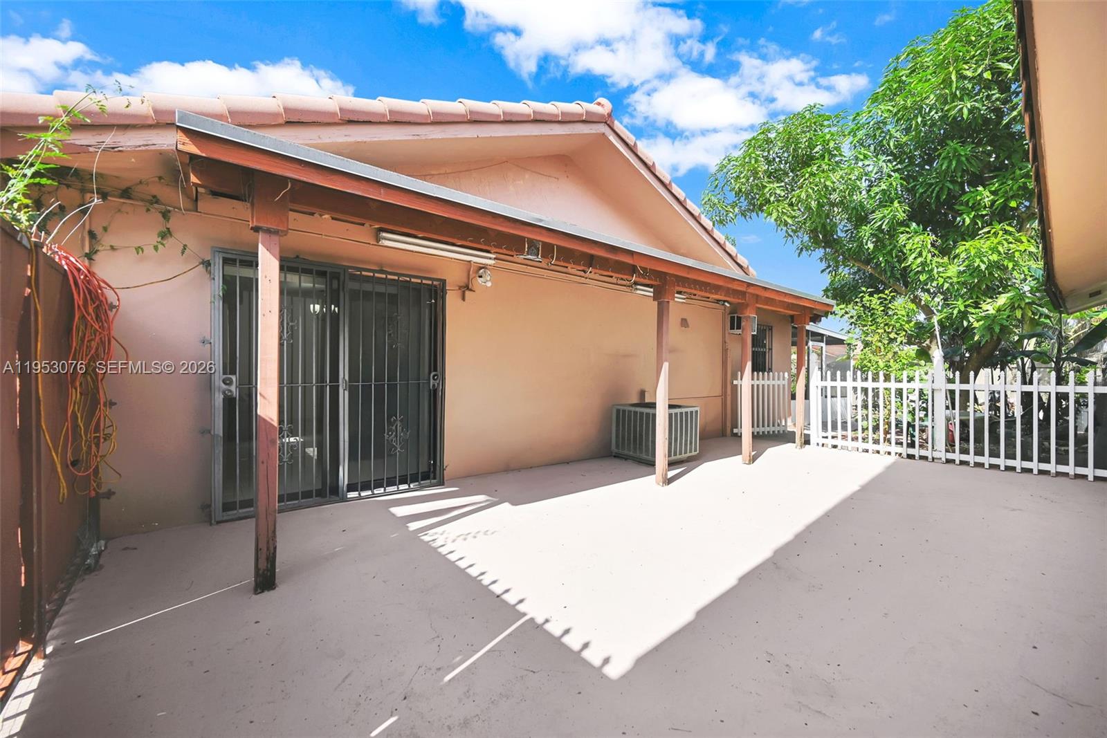 14837 Southwest 60th Street Miami, FL 33193 - Photo 4 of 21 a view of a house with a wooden fence