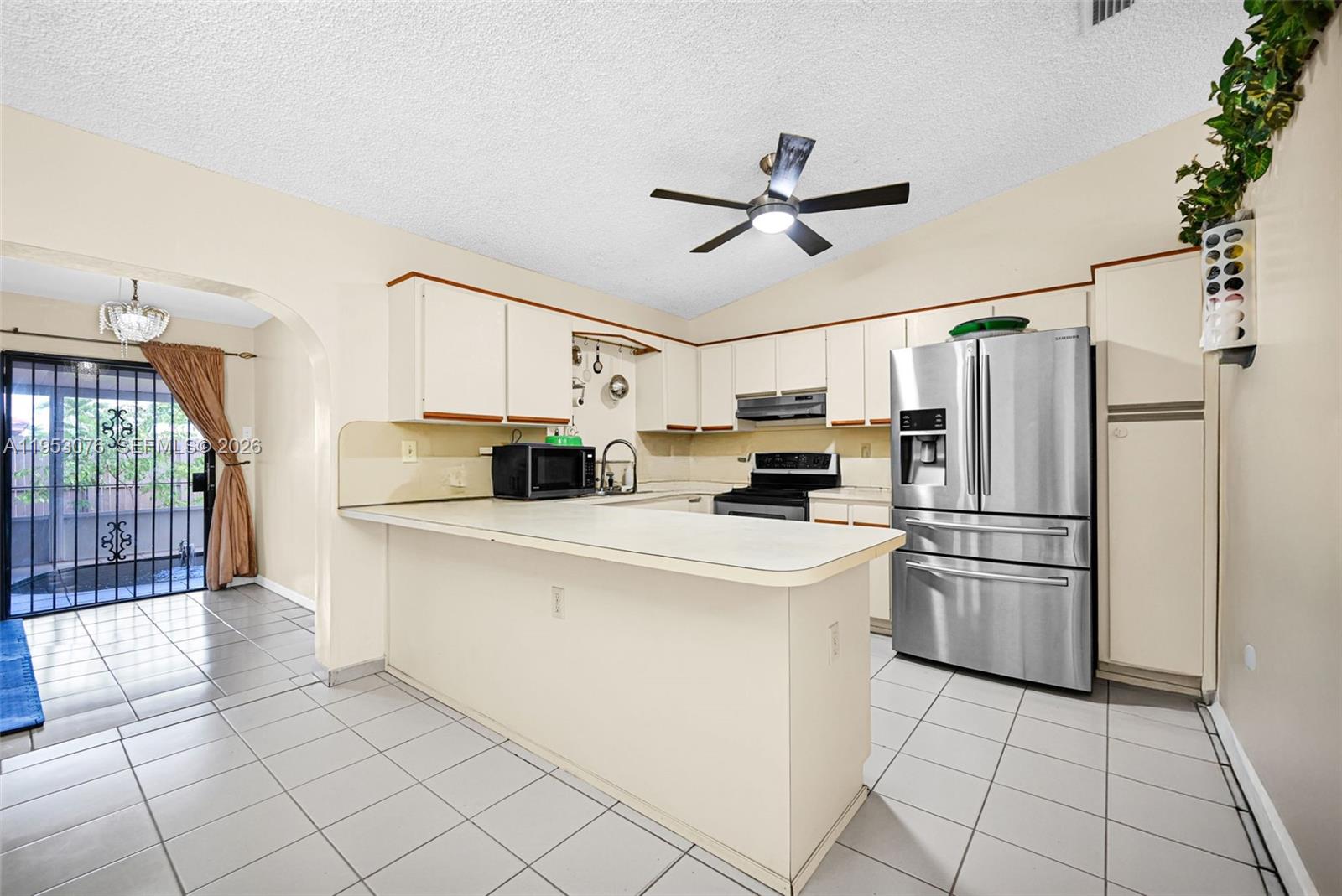 14837 Southwest 60th Street Miami, FL 33193 - Photo 10 of 21 a kitchen with stainless steel appliances a refrigerator sink and cabinets