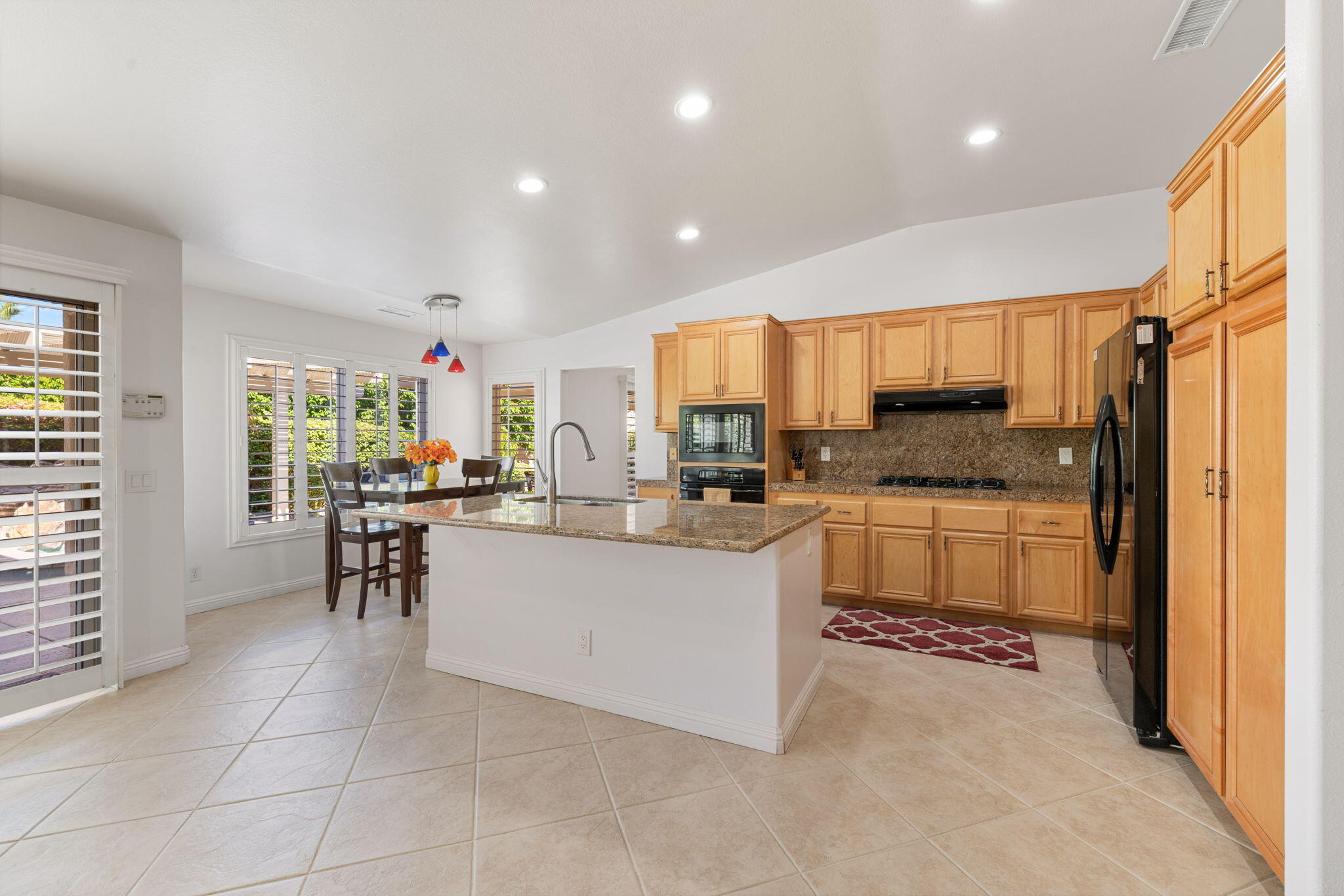 82420 Astaire Avenue Indio, CA 92201 - Photo 15 of 61 a kitchen with stainless steel appliances a refrigerator sink and cabinets