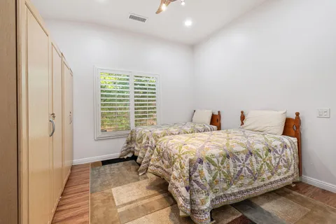 a bed sitting in a bedroom next to a window