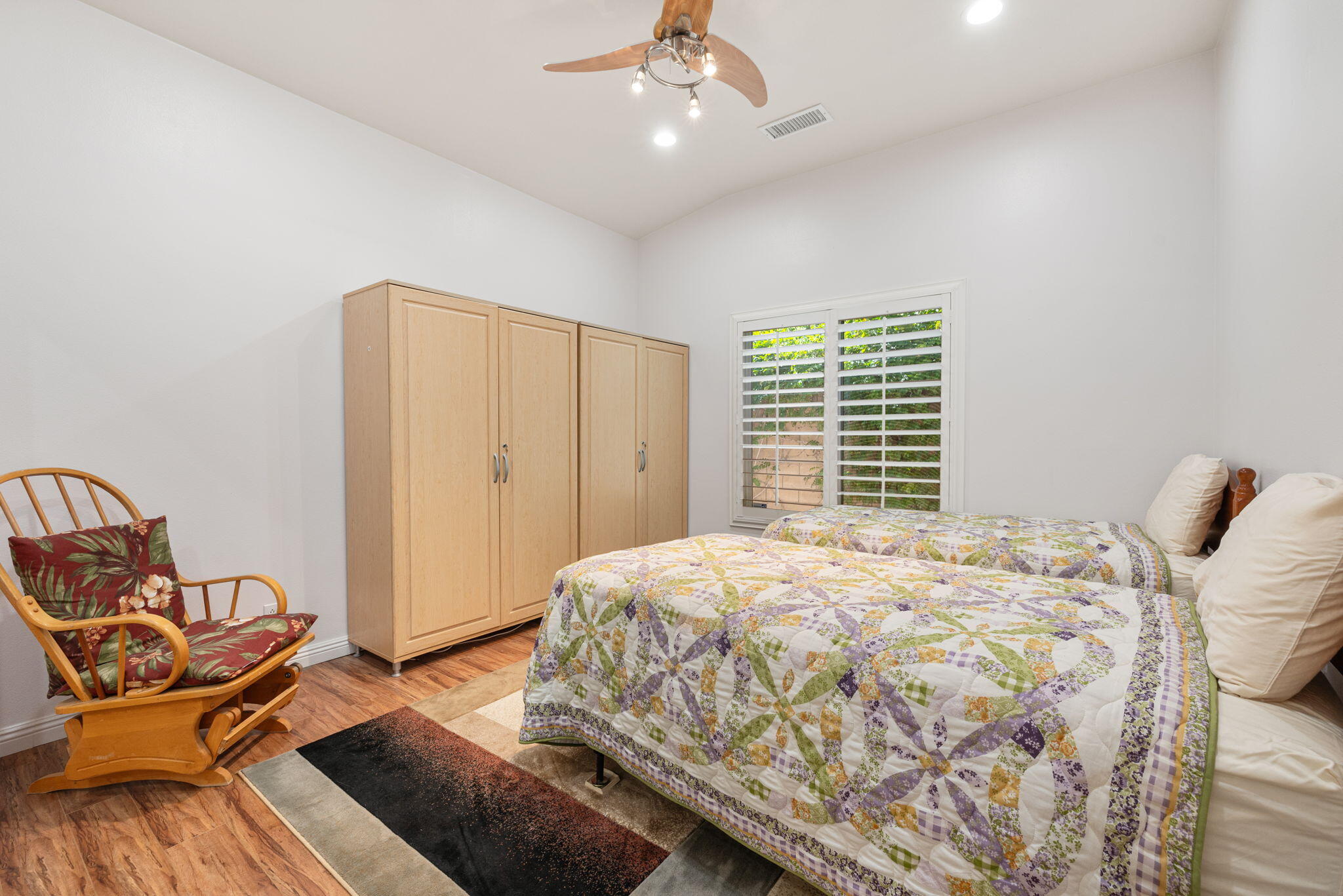 82420 Astaire Avenue Indio, CA 92201 - Photo 21 of 61 a bedroom with a bed and chair