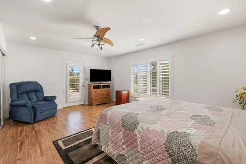 a spacious bedroom with a bed a window and walk in closet