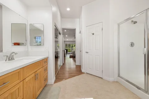 a bathroom with double vanity sink a window and a mirror
