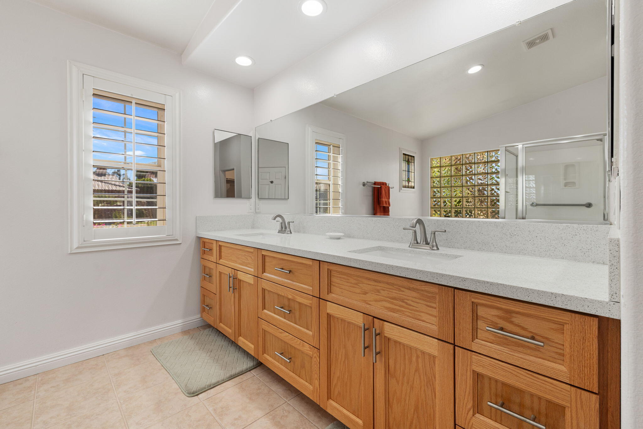 82420 Astaire Avenue Indio, CA 92201 - Photo 33 of 61 a bathroom with double vanity sink a window and a mirror