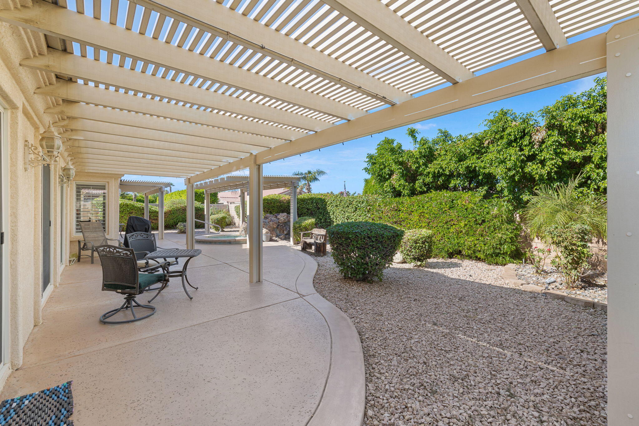 82420 Astaire Avenue Indio, CA 92201 - Photo 40 of 61 a building outdoor space with patio furniture and potted plants