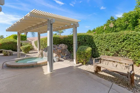 a view of a house with backyard porch and sitting area