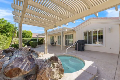 a view of a house with backyard sitting area and porch