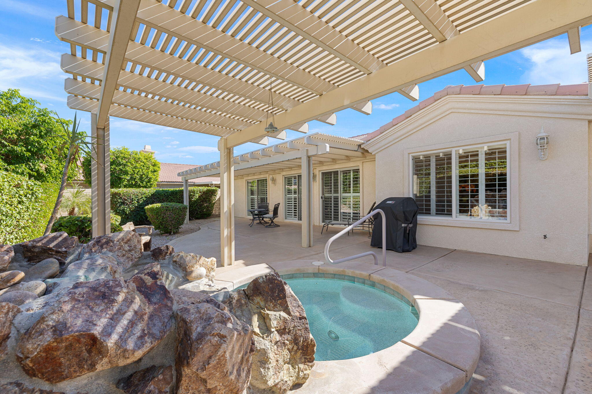 82420 Astaire Avenue Indio, CA 92201 - Photo 42 of 61 a view of a house with backyard porch and sitting area