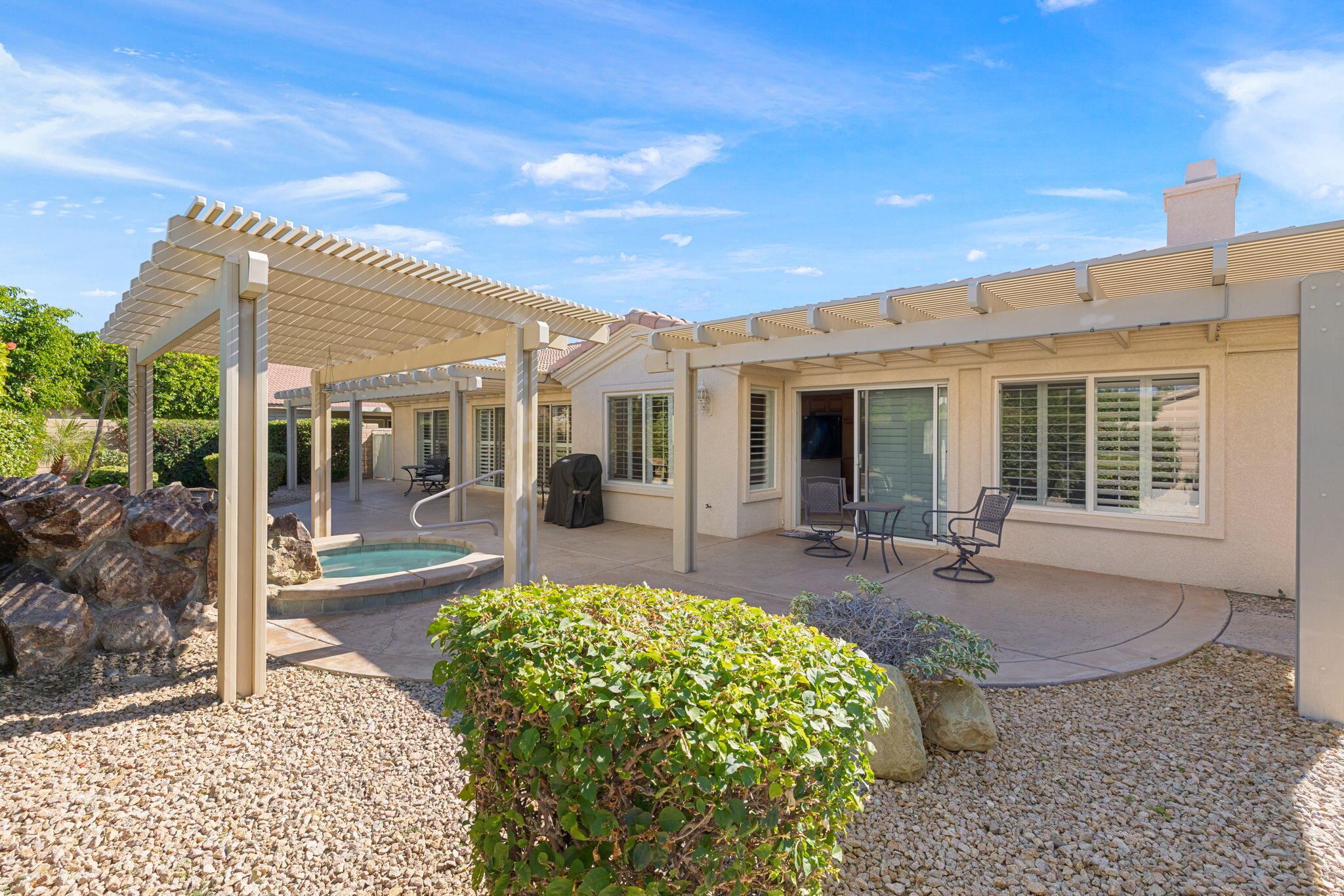 82420 Astaire Avenue Indio, CA 92201 - Photo 43 of 61 a view of a house with backyard sitting area and porch