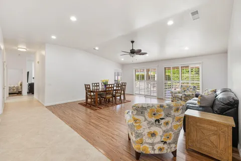a living room with furniture and large windows