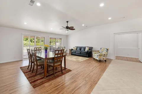 a view of a dining room with furniture and a wooden floor