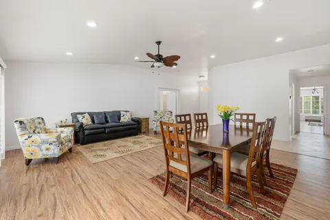 a view of a dining room with furniture and wooden floor