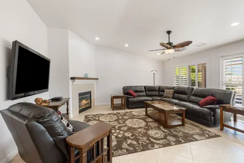 a living room with furniture flat screen tv and a fireplace