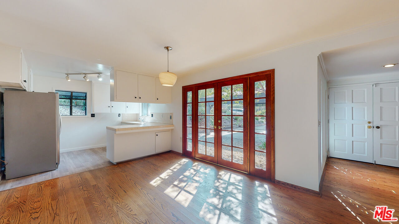 4535 El Prieto Road Altadena, CA 91001 - Photo 13 of 41 a large white kitchen with wooden floor and a large window