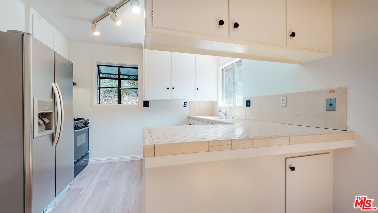 4535 El Prieto Road Altadena, CA 91001 - Photo 17 of 41 a kitchen with stainless steel appliances a refrigerator sink and cabinets