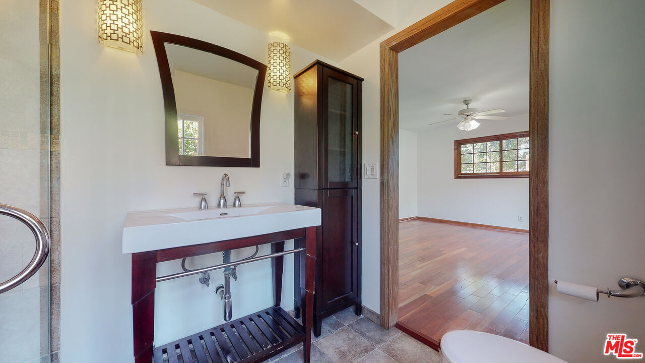 4535 El Prieto Road Altadena, CA 91001 - Photo 27 of 41 a bathroom with a sink a toilet and mirror