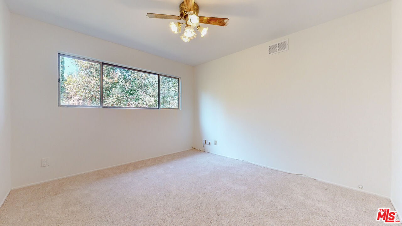 4535 El Prieto Road Altadena, CA 91001 - Photo 28 of 41 an empty room with a window and a fan