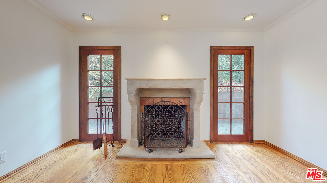 4535 El Prieto Road Altadena, CA 91001 - Photo 10 of 41 a view of an empty room with wooden floor fireplace and a window