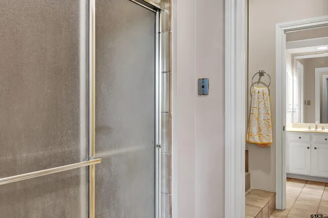 a bathroom with a glass shower door