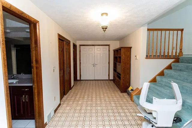 a view of a hallway with wooden floor and entryway