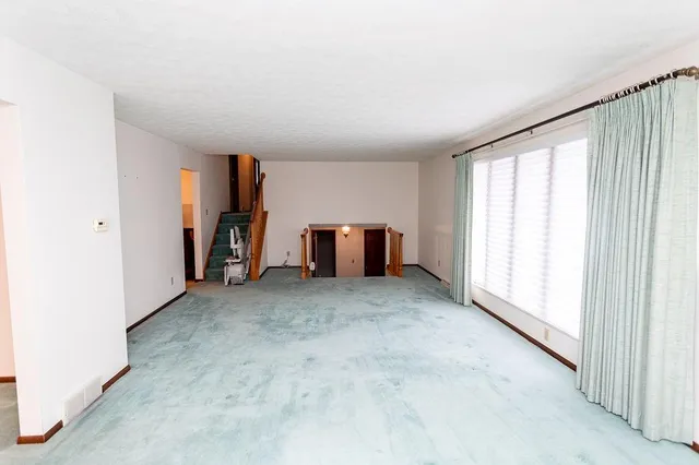 a view of a room with window and furniture