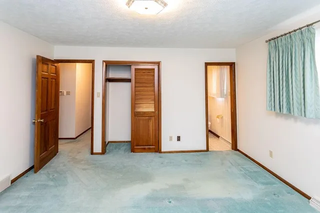 a bathroom with a granite countertop sink and a toilet