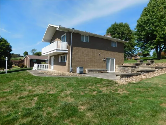 a view of a house with a yard porch and sitting area