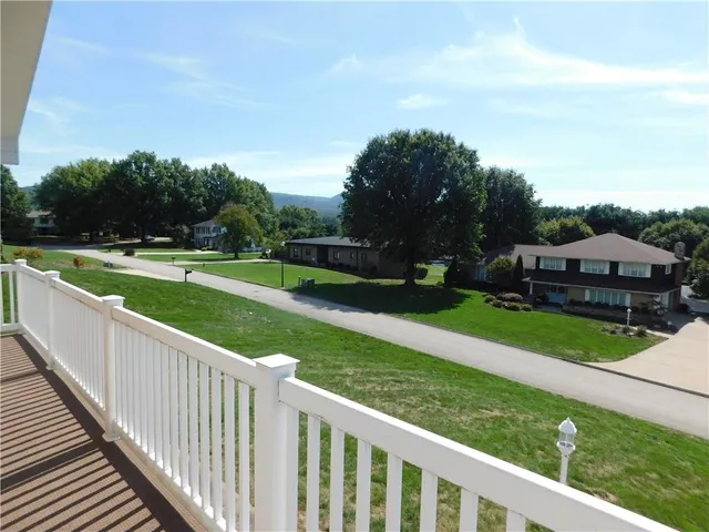 a view of a balcony with wooden fence