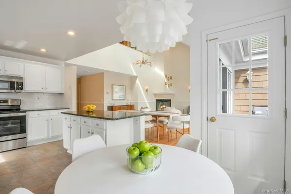 a kitchen with stainless steel appliances granite countertop a sink and a refrigerator