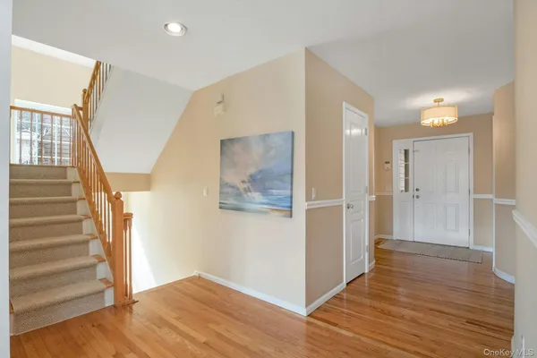 a view of an entryway with wooden floor