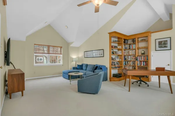 a living room with furniture and a ceiling fan