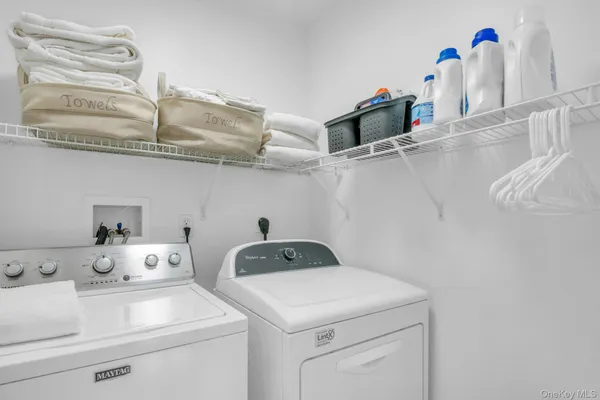 a bathroom with a granite countertop toilet sink and mirror