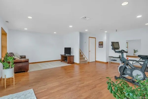 a view of a room with furniture wooden floor and windows