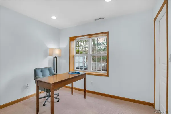 a view of a livingroom with furniture and a flat screen tv