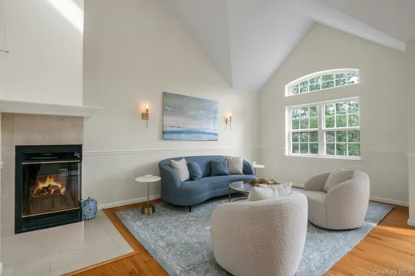 a dining room with furniture a chandelier and wooden floor