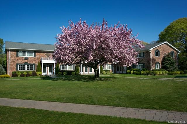 58 Horseblock Road, Unit 582A Centereach, NY 11720 - Photo 1 of 8 a front view of a house with a garden